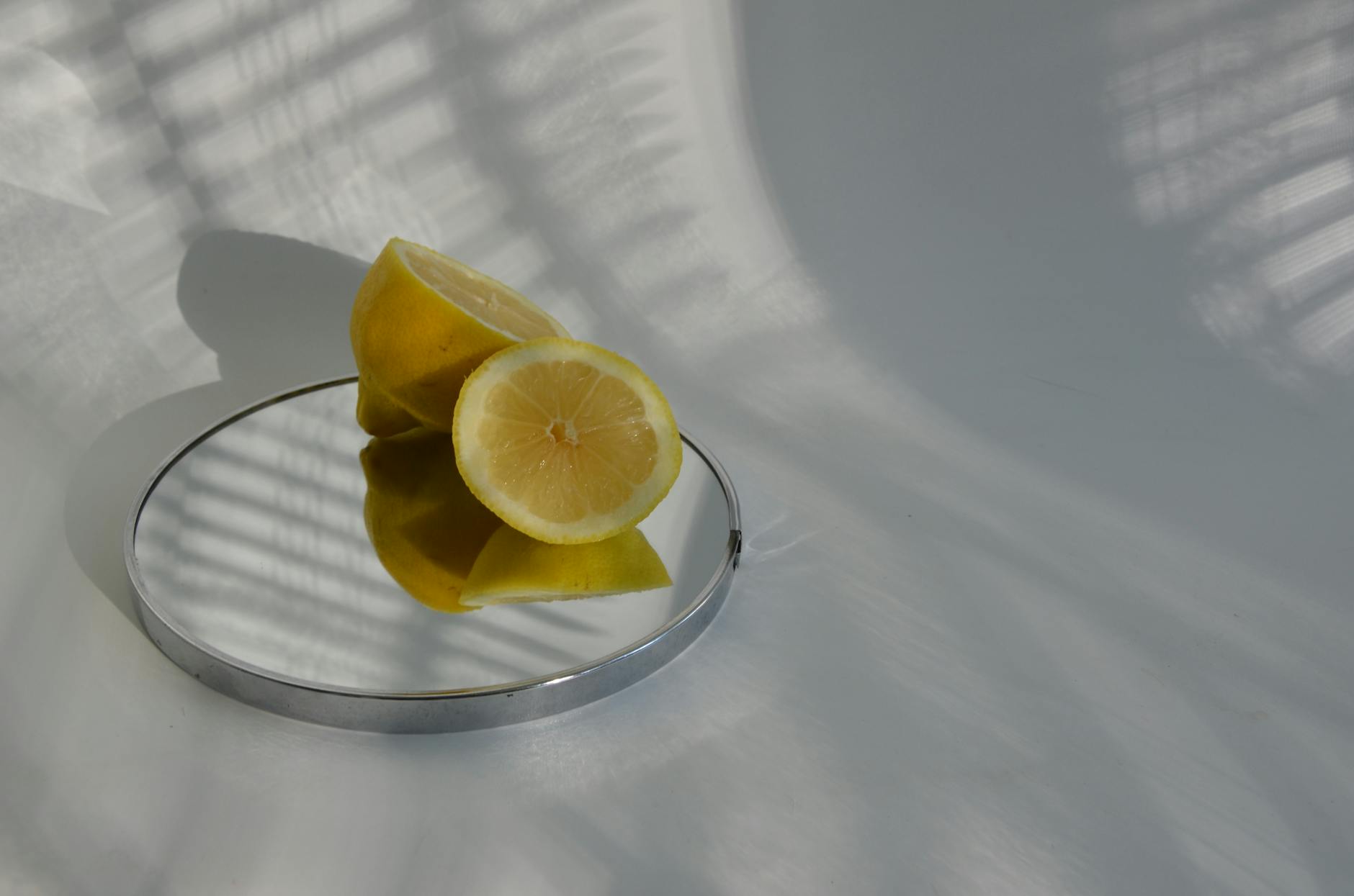 Hands holding pastel-colored silicone lemon vibrators against a neutral background.