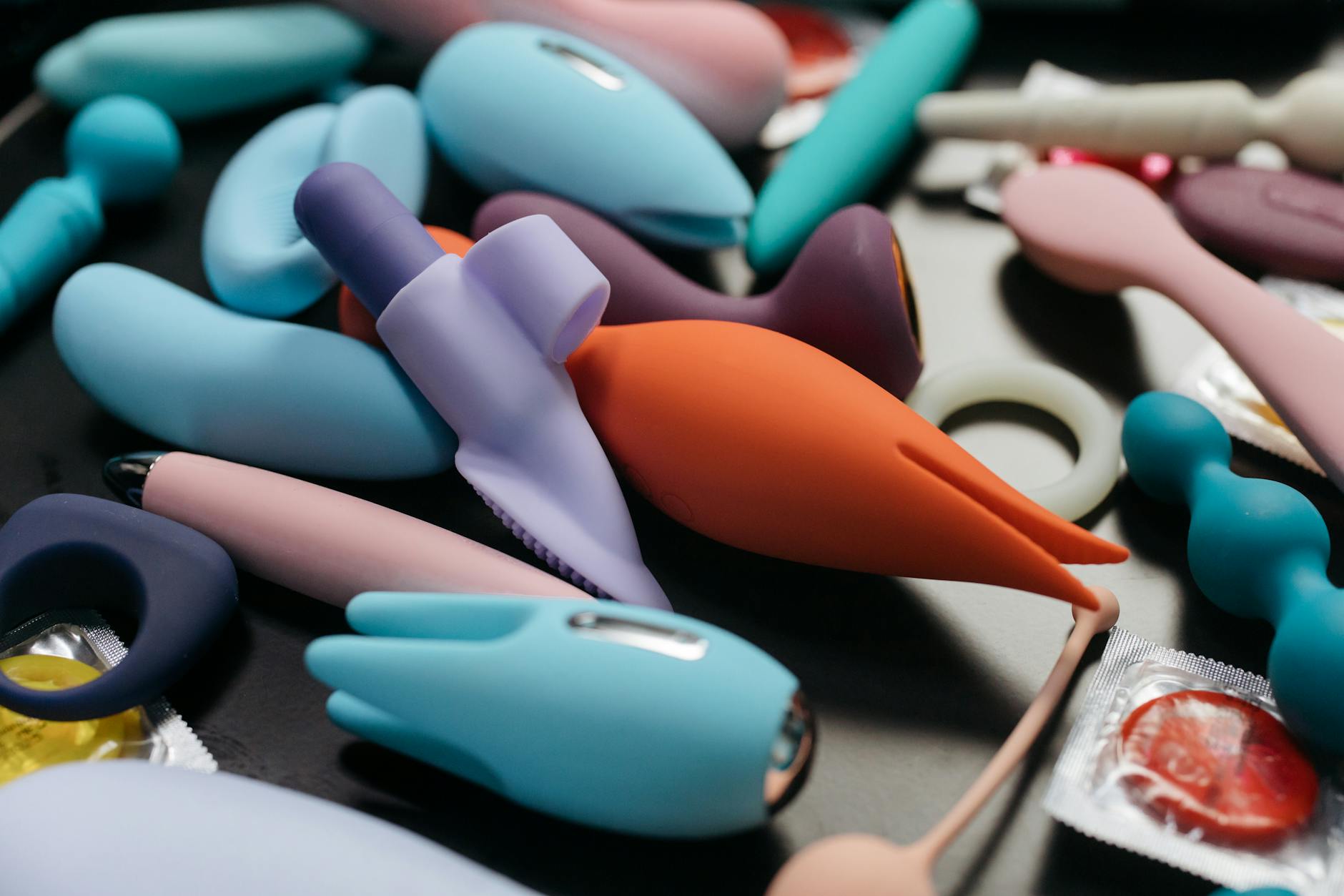 Hands holding a blue personal massager vibrator, showing the device up close.
