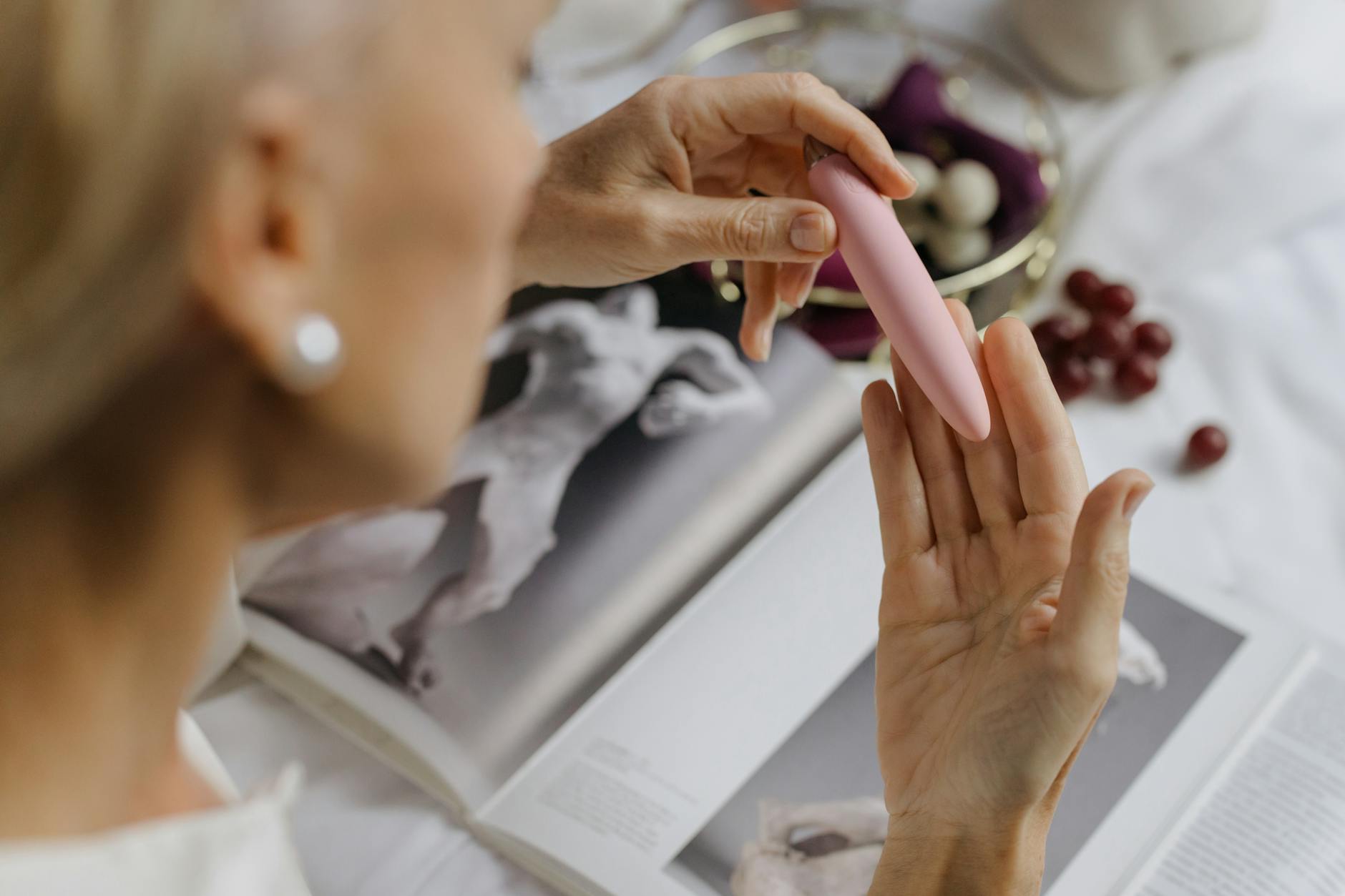 A young couple standing together indoors, exploring intimacy with a vibrator, symbolizing trust and reconnection.